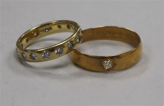 An 18ct gold and gypsy set diamond eternity ring and a 22ct gold wedding band.
